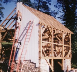 Structure enclosed with prepainted vertical barn siding.