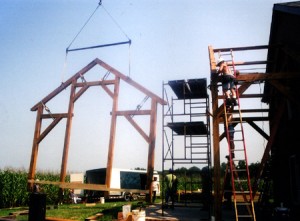 Picked by the crane, a bent for the project is guided into place.
