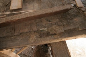 Removing materials like flooring often reveals hidden deterioration like the large void in this bent joist caused by a roof leak far above.