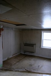 The interior had been covered in wallpaper, ceiling paneling, and various moldering floor coverings.