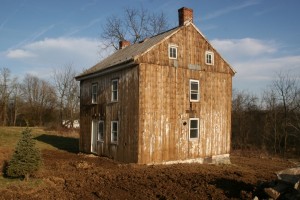 The old siding shows signs of whitewash from generations ago.