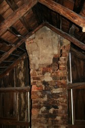 One of the two chimneys was so eroded that it was possible to reach into the flue from inside the attic.