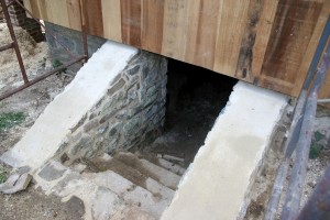Masonry repairs include repointing and capping the basement entrance areaway walls.