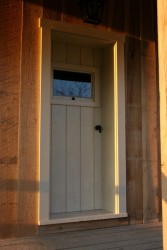 The doors are constructed of beaded tongue-and-groove boards and strong-backs, clinch nailed.  The depth of the jambs makes apparent the thickness of the log walls.