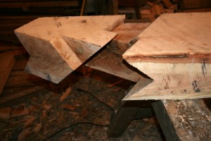 The bottom end is cut to sit on the square and level intersection of two large wall plate timbers.